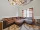 Cozy living room showcasing a large sectional sofa, patterned rug and unique ceiling art at 211 S Rowan Ave, Spencer, NC 28159