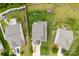 Birds eye view of houses with green grass and trees around the property at 225 Tasman Dr, Mount Holly, NC 28120