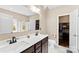 Double sink vanity in bathroom with a walk-in closet for storage at 225 Tasman Dr, Mount Holly, NC 28120
