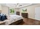 A bright bedroom with a ceiling fan, hardwood floors, and large windows for ample natural light at 225 Tasman Dr, Mount Holly, NC 28120