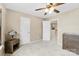 Bedroom featuring neutral walls, soft carpeting, and a wooden dresser with decorative lamp at 225 Tasman Dr, Mount Holly, NC 28120
