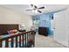 Stylized bedroom with blue accent wall, ceiling fan, themed bedding and decor plus a window seat and rocking chair at 225 Tasman Dr, Mount Holly, NC 28120