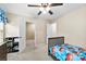 Well lit bedroom with ceiling fan, closet, adjacent room access and themed bedding and decor at 225 Tasman Dr, Mount Holly, NC 28120