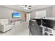 Bonus room with a neutral color scheme, lounge chair, mounted TV and three panel beach themed wall art at 225 Tasman Dr, Mount Holly, NC 28120
