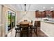 This dining area features wood flooring and a sliding door to a backyard patio at 225 Tasman Dr, Mount Holly, NC 28120