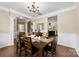Elegant dining room with a dark wood table, archway, and seamless access to other rooms at 225 Tasman Dr, Mount Holly, NC 28120