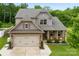 Charming two-story home with a two-car garage, covered porch, and well-maintained landscaping at 225 Tasman Dr, Mount Holly, NC 28120