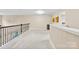 Large hallway with neutral carpets, iron railings, and lots of natural light at 225 Tasman Dr, Mount Holly, NC 28120