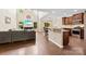 Open-concept living space with hardwood floors, a modern kitchen, and a vaulted ceiling at 225 Tasman Dr, Mount Holly, NC 28120