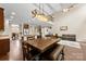Open floor plan with dining area, kitchen, living room, and access to the staircase at 225 Tasman Dr, Mount Holly, NC 28120