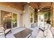 Covered outdoor patio with string lights, ceiling fan, comfortable seating, and a view of the backyard at 225 Tasman Dr, Mount Holly, NC 28120