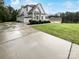 Contemporary home featuring a long concrete driveway, lush lawn, and charming curb appeal at 263 Lauren Pines Dr, York, SC 29745