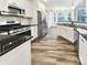 Modern kitchen with stainless steel appliances, black countertops, and white cabinetry at 263 Lauren Pines Dr, York, SC 29745