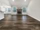 Bright living room boasts hardwood floors, large windows, and a cozy stone fireplace at 263 Lauren Pines Dr, York, SC 29745
