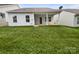 Spacious backyard featuring a covered patio, lush green lawn, and providing an ideal space for outdoor enjoyment at 27415 Cinderella Cir, Lancaster, SC 29720