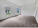 Cozy bedroom featuring neutral carpeting and two windows, offering a serene and comfortable living space at 27415 Cinderella Cir, Lancaster, SC 29720