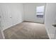 Bright, carpeted bedroom with a window and closet is move-in ready at 27415 Cinderella Cir, Lancaster, SC 29720