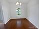 Dining room with hardwood floors, chandelier, and a window providing natural light, perfect for Gathering meals at 27415 Cinderella Cir, Lancaster, SC 29720