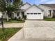 Charming one-story home featuring a light gray exterior, well-manicured landscaping, and an attached two-car garage at 27415 Cinderella Cir, Lancaster, SC 29720