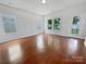 Bright and airy living room with hardwood floors, multiple windows providing lots of natural light, and a glass exterior door at 27415 Cinderella Cir, Lancaster, SC 29720