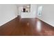 Bright and airy living room with hardwood floors, a half wall to the kitchen, and multiple windows providing natural light at 27415 Cinderella Cir, Lancaster, SC 29720