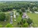 Scenic aerial view showcasing homes nestled among trees and open fields at 3345 Long Ferry Rd, Salisbury, NC 28146