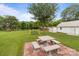 Picturesque backyard featuring a stone picnic table under a mature tree, perfect for outdoor gatherings at 3345 Long Ferry Rd, Salisbury, NC 28146