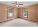 Bedroom featuring two windows, paneled walls and a ceiling fan at 3345 Long Ferry Rd, Salisbury, NC 28146