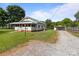 Home with a gravel driveway leading to a detached carport and fenced yard at 3345 Long Ferry Rd, Salisbury, NC 28146