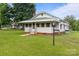 Inviting home featuring a well-maintained lawn and a cozy front porch at 3345 Long Ferry Rd, Salisbury, NC 28146