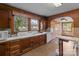 Kitchen featuring dark wood paneled walls, custom cabinets and white appliances at 3345 Long Ferry Rd, Salisbury, NC 28146