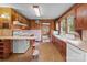 Kitchen features dark wood paneled walls, custom cabinets and white appliances at 3345 Long Ferry Rd, Salisbury, NC 28146