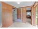 A cozy living room featuring carpeted floors and wood-paneled walls with multiple entrances to other rooms at 3345 Long Ferry Rd, Salisbury, NC 28146