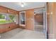 A cozy living room featuring carpeted floors, wood-paneled walls, and lots of natural light from surrounding windows at 3345 Long Ferry Rd, Salisbury, NC 28146