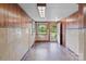 A room with paneled walls, neutral tile and an exterior door at 3345 Long Ferry Rd, Salisbury, NC 28146
