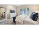 Comfortable bedroom showcasing a large window, plush bedding, and ample storage space at 3722 Ellington St, Charlotte, NC 28211