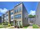 Attractive exterior view of a new townhome featuring brick and gray siding with manicured landscaping at 3722 Ellington St, Charlotte, NC 28211