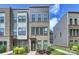 Attractive exterior view of a new townhome featuring brick and gray siding with manicured landscaping at 3722 Ellington St, Charlotte, NC 28211