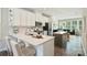 Stylish kitchen boasts white cabinets, stainless steel appliances, and a center island, open to the living room at 3722 Ellington St, Charlotte, NC 28211
