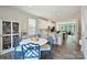 Bright kitchen and dining area features white cabinets, stainless appliances, and stylish blue chairs at 3722 Ellington St, Charlotte, NC 28211