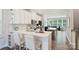 Modern kitchen with white cabinets, stainless steel appliances, and an island, flowing into the living area at 3722 Ellington St, Charlotte, NC 28211