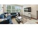 Comfortable living room featuring a large blue sectional, bright windows, and modern furnishings at 3722 Ellington St, Charlotte, NC 28211