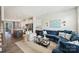 Open-concept living room featuring a blue sectional sofa and seamlessly flowing into the modern kitchen at 3722 Ellington St, Charlotte, NC 28211