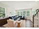 Bright living room with a plush blue sectional, large windows, and stylish decor at 3722 Ellington St, Charlotte, NC 28211