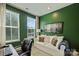 Home office with dark green walls, two windows, and a comfortable white sofa at 3722 Ellington St, Charlotte, NC 28211