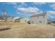 Spacious backyard view of the home featuring a well-maintained lawn and exterior of the house at 427 Carolina Hemlock Dr, Locust, NC 28097