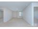 A well lit bedroom with beige carpet and neutral colored walls and a window for natural light at 427 Carolina Hemlock Dr, Locust, NC 28097