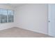 A well lit bedroom with beige carpet and neutral colored walls and a window for natural light at 427 Carolina Hemlock Dr, Locust, NC 28097