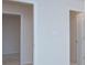 Hallway featuring two doorways and a light switch, neutral paint and carpet at 427 Carolina Hemlock Dr, Locust, NC 28097