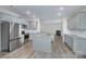 Bright kitchen featuring granite countertops, light gray cabinets, stainless steel appliances, and hardwood floors at 427 Carolina Hemlock Dr, Locust, NC 28097